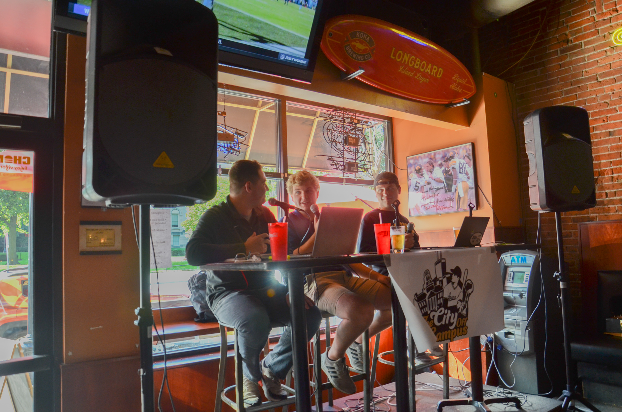 Sammy Sommerfeld (left) and Jack McFarland (right) talk with Sean Bock (middle) about the upcoming Iowa football game.