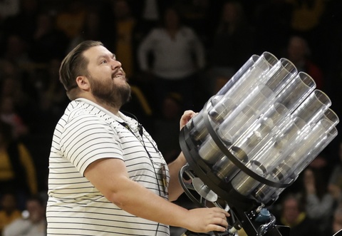 Jake Anderson using t-shirt cannon at basketball game