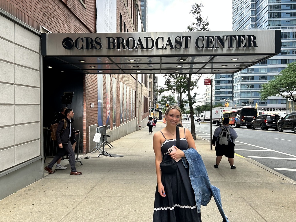 This is a photo of SJMC student Grace Lathrop in front of CBS New York.
