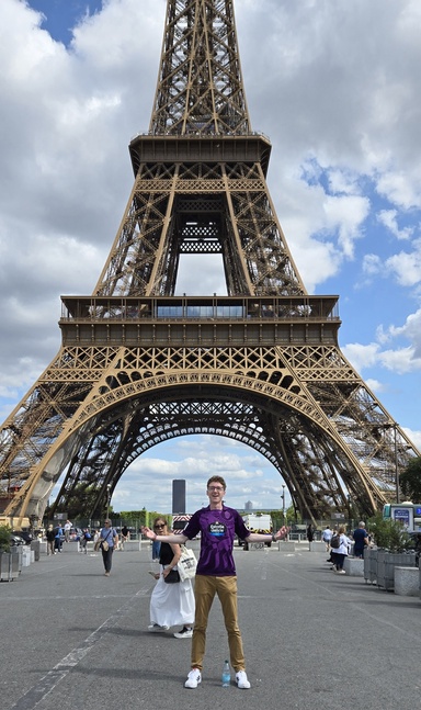 An image of Sean Keene standing in front of the Eiffel Tower.