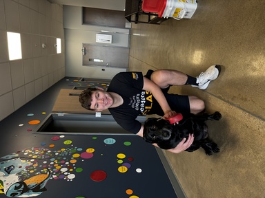 This is a photo of SJMC student Jered Kerr with his dog.