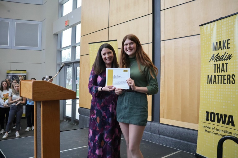 SJMC senior Alice Cruse and director Melissa Tully at the student exhibition on Tuesday, April 10, 2025. Cruse won first place for the Outstanding Writing Award.