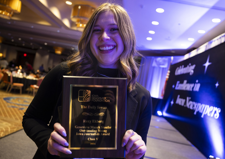 A photo of Roxy Ekberg holding the Mauck Stouffer award.