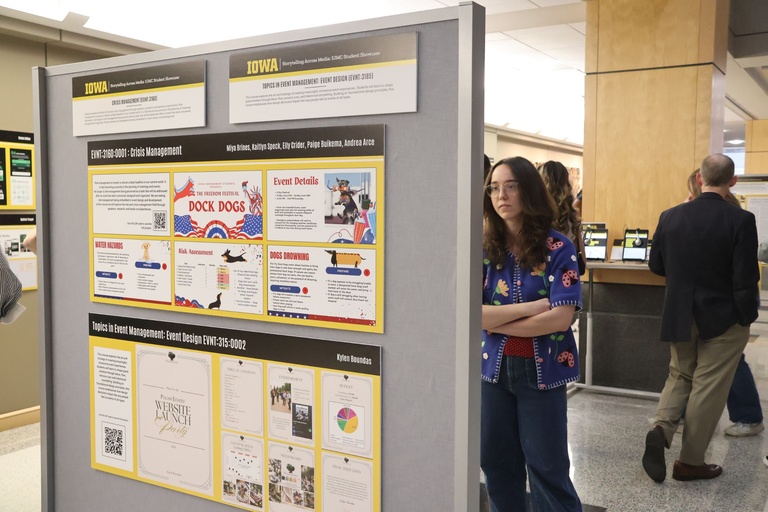 This is a photo of a student viewing work at the 2026 Student Exhibition