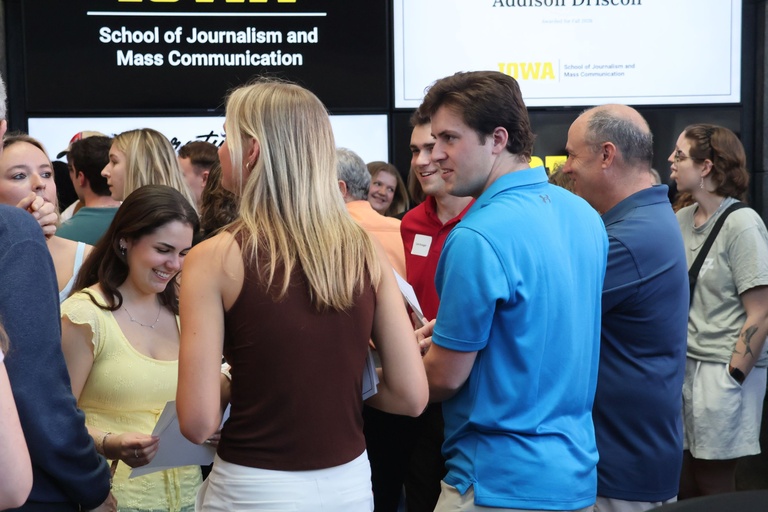 This is a photo of students being social at the 2026 Student Exhibition