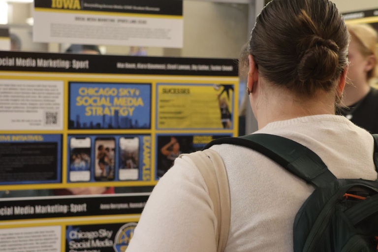 This is a student looking at work presented at the 2026 Student Exhibition