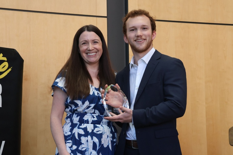 This is a photo of Aidan Wirtz winning the SJMC Outstanding Writing Award
