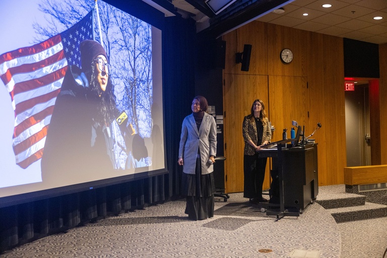 This is a photo of Kabedi Mutamba and Leah Latella talking about one of Kabedi's photos.