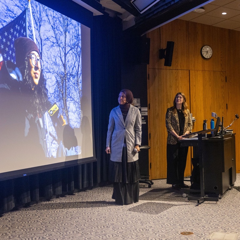 This is a photo of Kabedi Mutamba and Leah Latella talking about one of Kabedi's photos.