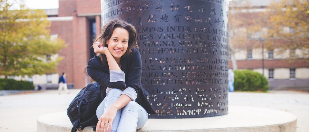 Journalism student outside of Adler Journalism Building