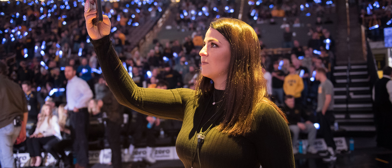 a woman working courtside at a sporting event