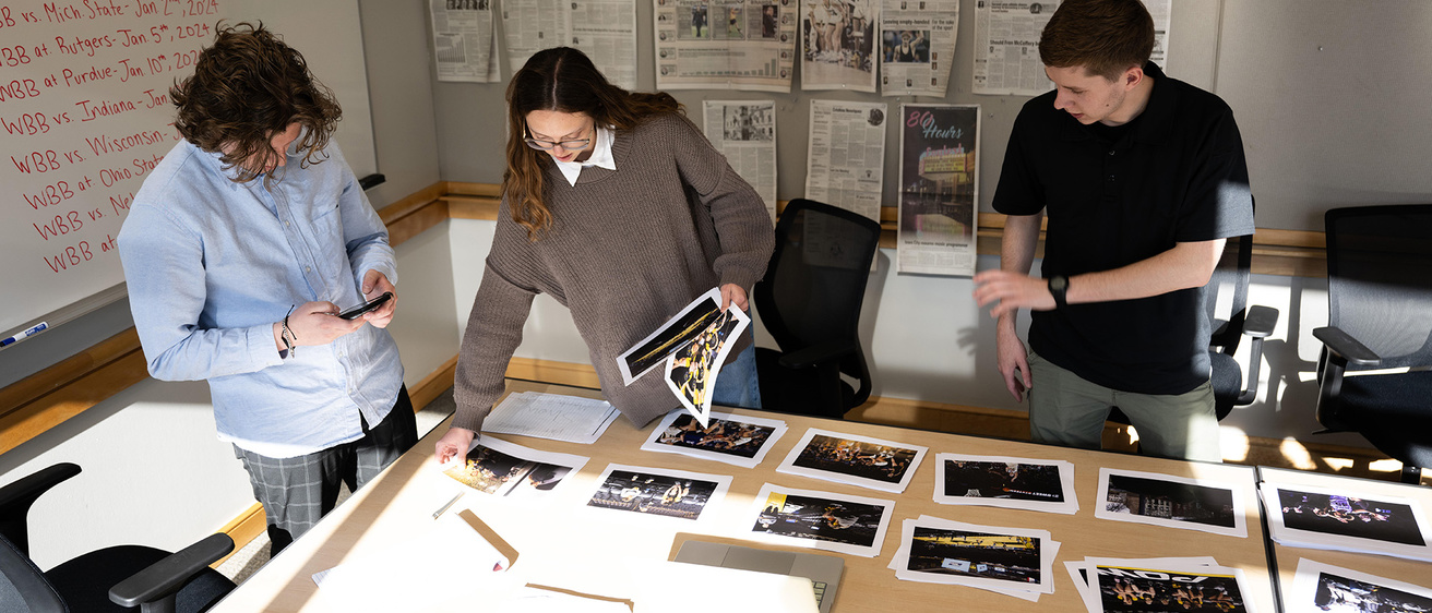 student journalists selecting photos