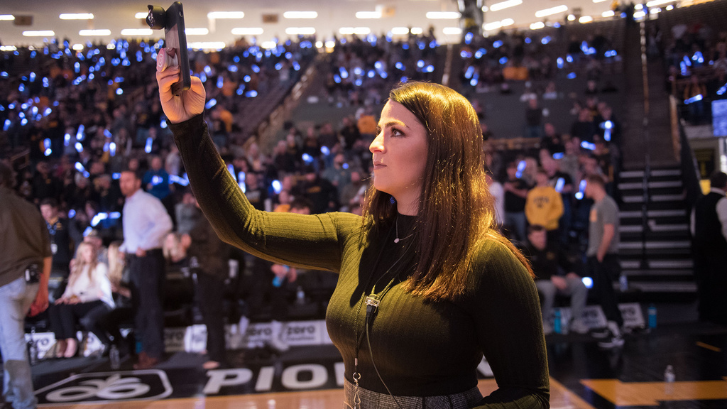 a woman working courtside at a sporting event