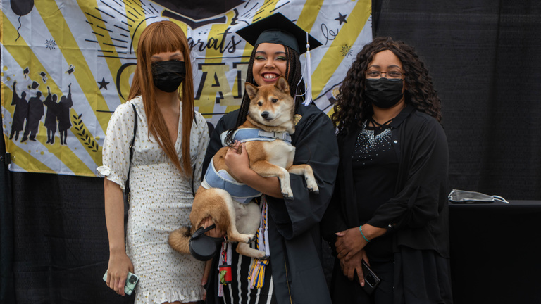 Nicole Shaw poses for a picture on stage with her family – including her dog.